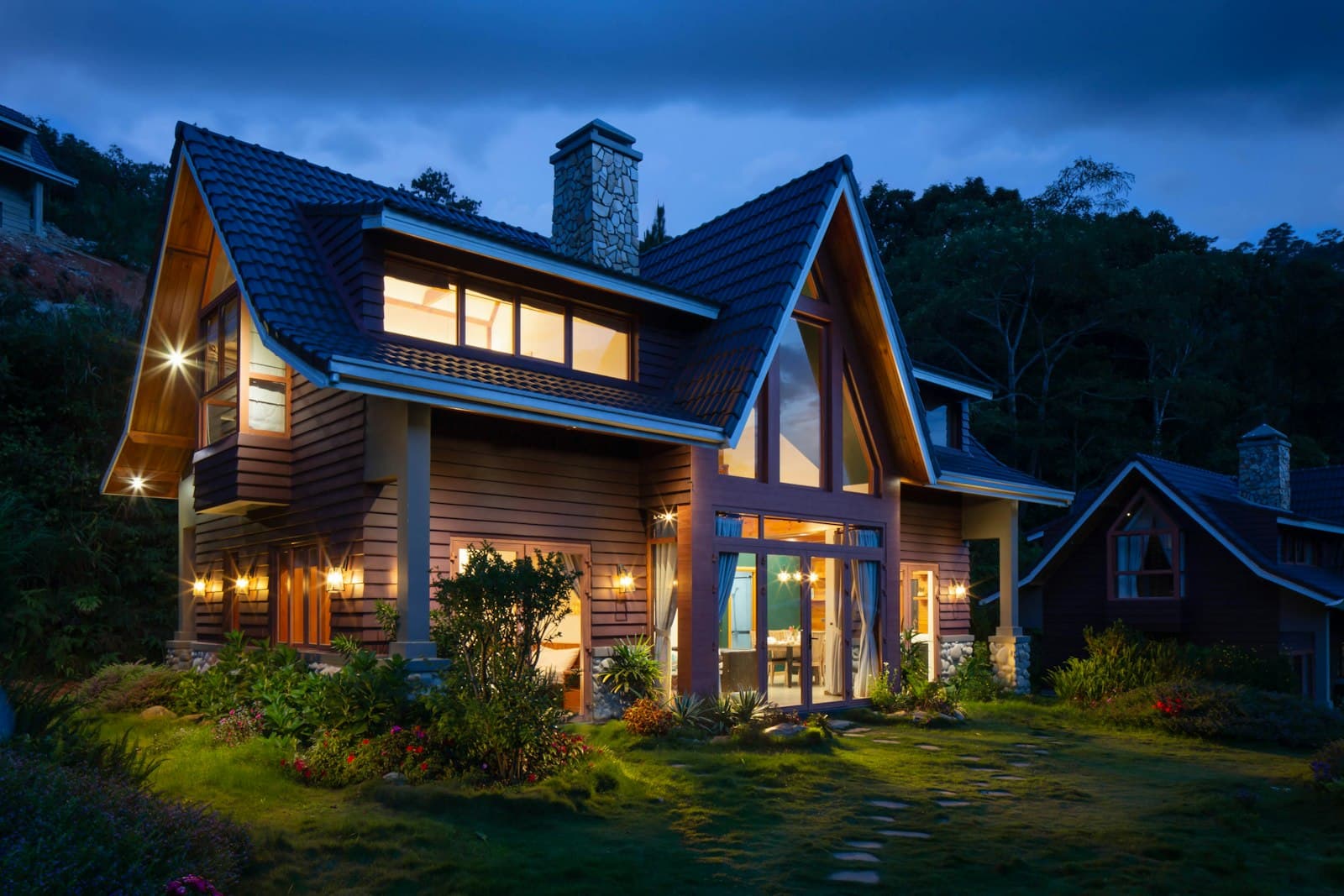 Elegant manufactured home glowing at dusk with manicured landscaping